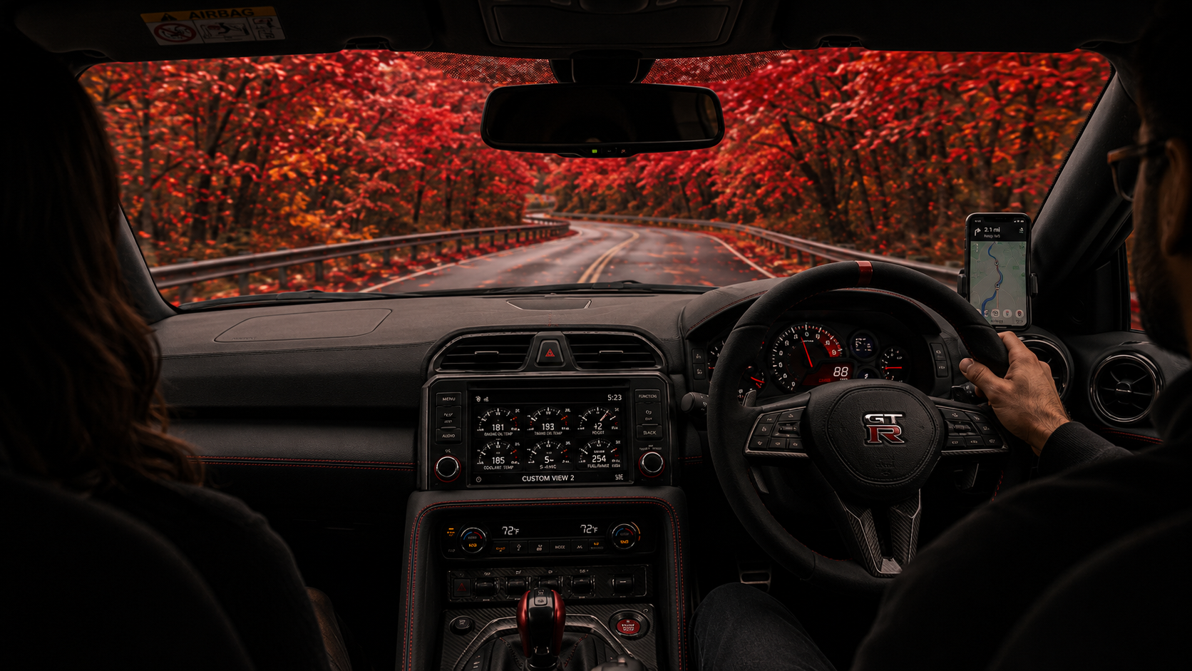 In-car view on a scenic road during driver training.